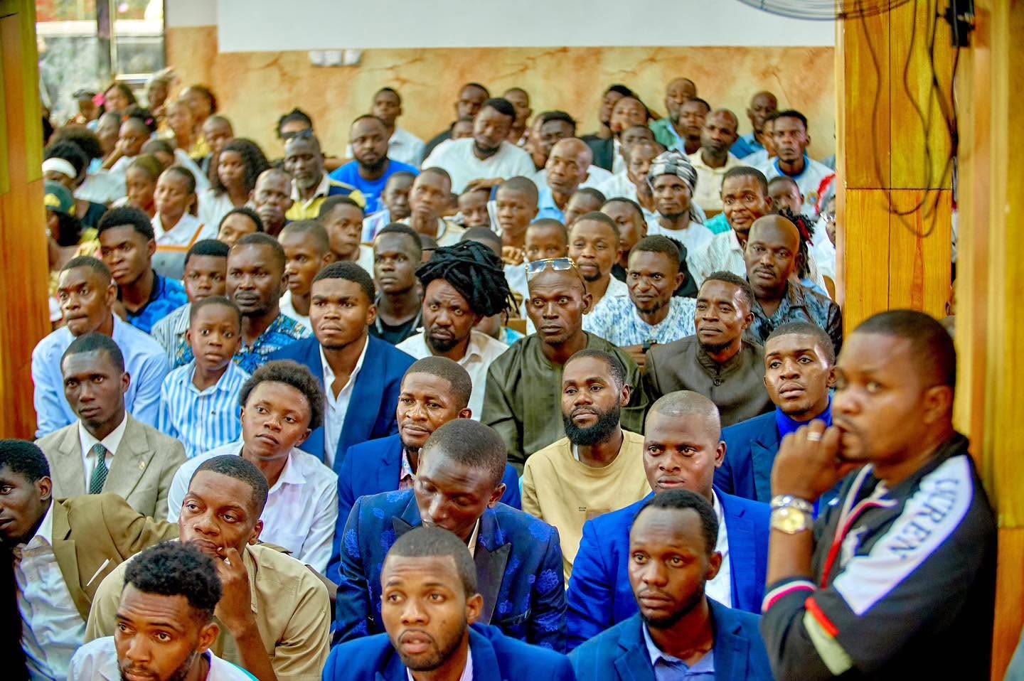 Hommes de l’Église assis lors d’un rassemblement Liloba